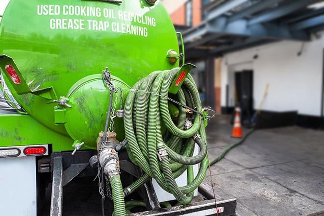 maintenance crew pumping grease trap at a fast food restaurant in Apollo Beach